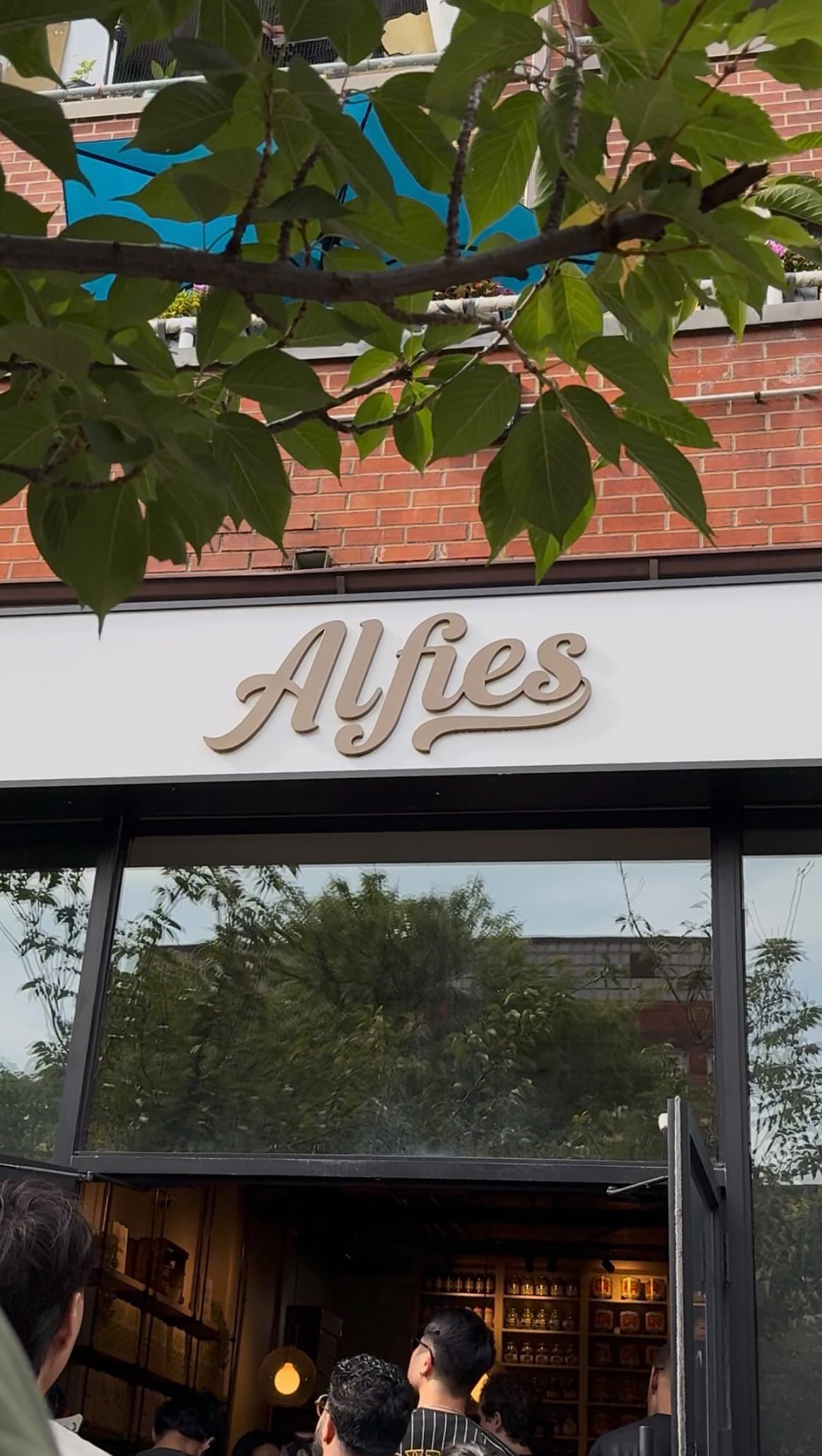 The Alfie’s storefront sign above a brick café entrance